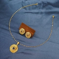 Detail of gold-tone woven knot jewelry set on blue fabric background with a wood block - E6107-15/Gold Round Woven Knot