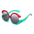 Oversized cat-eye sunglasses with red and green color-block geometric frames and grey lenses - Red and Cyan