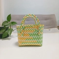 Close-up of a woven mini tote bag in green, yellow, and white plastic weave pattern - Mini Yellow and Green Contrast