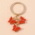 Llavero de mariposa con purpurina roja y anillo dorado para bolsos y mochilas - Brillo Rojo (YZ172hongse)