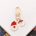 Detailed view of gold metal keychain with Santa Claus and red crescent enamel charms - Santa Claus-9 (with Hat Moon)