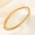 Elegant 5mm golden stainless steel beaded bracelet featuring faceted ball textures on silk - Gold