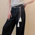 Close-up of woven rope belt with tassels on dark indigo wide-leg denim jeans - Ethnic Style Three-color Interwoven Braided Tassel Waist Chain