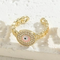 Golden chain ring featuring a pink and black evil eye motif with zircon accents - Pink