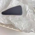 Detail view of dark gray textured triangular hair clip on white aesthetic background - Gray