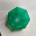 Translucent green 7-day pill organizer box with circular 7-compartment weekly design - Army Green