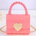 Mini heart-shaped jelly handbag in bright pink with twist handle and golden chain - Pink