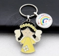 Detail of metal keychain featuring cartoon angel and rainbow Schulkind charm on leather wallet - Lemon Yellow