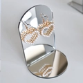 Golden heart earrings with white faux pearls on a mirrored jewelry display stand - Round Base Short 10cm