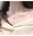 Detail of silver heart pendant necklace with pearls on neck for an elegant look - Silver Pearl Heart Necklace