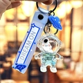 Portachiavi astronauta blu con figura trasparente e cinturino in silicone - Astronauta dell'Oceano Blu - Viso Nero Seduto