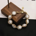 18k gold plated pearl bracelet with rhinestone accents and a heart charm on wood base - 8-Pearl Bezel-Set Bracelet