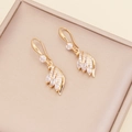 Elegant gold feather earrings with sparkling zircon crystals in a beige jewelry gift box - Earrings / White