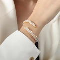 Elegant gold plated bangle with marquise cut white zircons for a luxury fashion look - White Zircon Gold Color