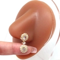 Macro view of golden double-drop earrings with sparkling crystals on an ear model - Gold Round Pendant