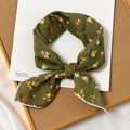 Green floral cotton linen square scarf tied in a knot on a decorative background - Vine Green Base