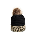 Close-up of knitted beanie featuring leopard print hem and a brown faux fur pom-pom - M (56-58cm) / Black