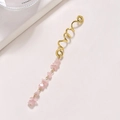 Gold spiral hair accessory featuring a natural pink crystal stone pendant on white surface - Light Pink Long