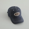 Detailed close-up of dark blue washed denim baseball cap with brown WORLD embroidery patch - Letter WORLD / Navy Blue