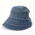 Close-up of washed blue denim bucket hat featuring vintage metal logo and stitched brim - 55-59cm (Adjustable) / Medium Blue