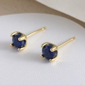Minimalist gold plated stud earrings featuring round navy blue zircon in four-prong setting - Gold Blue