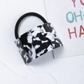 Macro detail of acetate geometric charm with black and white marble pattern on hair tie - Black & White