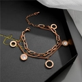 Detail of rose gold double-layer bracelet with Roman numeral charms and lobster clasp - Rose Gold - Black & White Roman Numerals