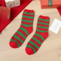 Thick red and green striped Christmas coral fleece socks on a festive wooden background - Red & Green Stripes