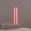 Pink 10ml portable aluminum perfume spray bottle with silver ring on clear acrylic stand - 10ml / Pink