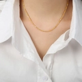 Minimalist gold plated titanium necklace with geometric link design on model - Fine Style / Gold