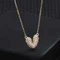 Elegant gold plated necklace with micro-pave pink zircon heart pendant on dark stand - Gold