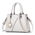 Beige minimalist faux leather handbag with black trim and heart-shaped metal charm - White