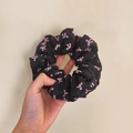 Elegant large black scrunchie with pink bow pattern held by hand on beige background - Q616-1 Black Pink Bow Large