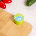 Close-up of portable mini sauce container with cute bear pattern on a wooden board - Bear / Green