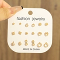 Nine-piece gold stud earring set featuring heart, star, and pearl designs on display card - KC Gold (0796)