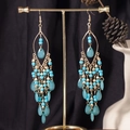 Bohemian teardrop tassel earrings with blue beads and gold metal on a display stand - S4286-2 Blue Acrylic Water Drop Earrings