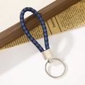 Portachiavi in pelle intrecciata blu e nera con anello di connessione in metallo argento - Marino e Nero