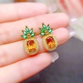 Macro shot of pineapple earrings with orange stones and green gemstone leaves - Stud Earrings (Pair)