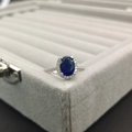 Classic silver ring with large oval blue gemstone and shimmering halo accents - Size 5 / Sapphire