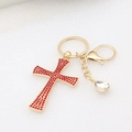 Detail of a gold cross keychain with red rhinestones and clear crystal teardrop charm - Red