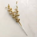 Dettaglio del ramo di bacche di Natale dorate e glitterate su marmo bianco - Oro