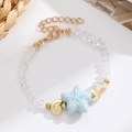Detailed shot of ocean-style bracelet with blue starfish, gold shell, and heart crystal - KC Gold Blue (8903)