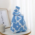 Close-up of a blue and white floral knit tote bag with a unique knotted handle design - Blue Full Flower