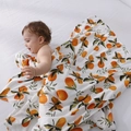 Bamboo cotton baby swaddle blanket featuring bright orange prints on a soft white fabric - Orange