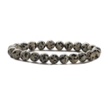 Detailed view of polished black and white spotted stone beads on a stretch bracelet - Spotted Stone