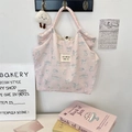 Close-up of pink floral canvas tote with cat print and decorative white lamb charm - Printed Cat Pink