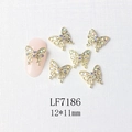 Detail of 12x11mm golden butterfly nail art charms with colorful rhinestones on a pink nail - Gold Micro-Pave Aurora Butterfly (7186)