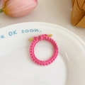 Pink elastic hair tie with wavy crochet texture and decorative gold hardware detail - Rose Red