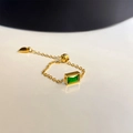 Detailed macro view of adjustable gold chain ring with emerald green zircon and heart charm - F10092 Green Zircon Adjustable Link Gold