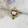 Golden heart pendant with red butterfly design and black gemstone on white fabric - 15-Gold Red White Butterfly Heart
